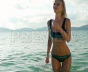 Get this here: https://motionarray.com/stock-video/thailand-island-beach-vacation-270668n...included with our Unlimited memberships. Or download hundreds of other assets with a FREE account. https://motionarray.com/freennThis video shows a blonde woman wading through hip-deep water off the coast of Koh Tean beach in Thailand.