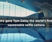 Olympic Swimmer Tom Daley is challenged to use the &#39;squeezie&#39; selfie function on the new HTC U11 and take a selfie mid dive. Easy squeezy lemon peezy. Not. Agency: H&amp;G (Nathan Gallagher) Date: June 2017