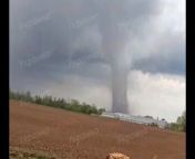 Video of a large tornado tearing through open countryside near the village of Erkov/Yerkiv, Ukraine. The tornado&#39;s intensity is unknown. Sorry about the watermarks.&#60;br/&#62;&#60;br/&#62;Video credits unkown.