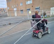 Bizarre video shows a man on a mobility scooter dragging a metal fence along a busy main road.&#60;br/&#62;&#60;br/&#62;The pensioner was spotted pulling the unusual load as he stopped at traffic lights in Grimsby.&#60;br/&#62;&#60;br/&#62;The large steel palisade fence was tied to the vehicle&#39;s headrest while the man towed it on the road behind him.