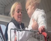 In this video, a mother struggles to put her toddler in the shopping cart chair because the toddler refuses to bend their legs. The situation is portrayed in a comical light, with the mother&#39;s exasperation evident as she tries to maneuver the uncooperative child into the seat. Despite her efforts, the toddler&#39;s resistance adds to the humor of the moment. The mother&#39;s audible sigh of relief when she finally succeeds in getting the toddler seated adds to the comedic effect, highlighting the everyday challenges of parenting in a lighthearted manner.&#60;br/&#62;Location: United Kingdom&#60;br/&#62;WooGlobe Ref : WGA443649&#60;br/&#62;For licensing and to use this video, please email licensing@wooglobe.com