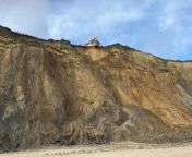 Two homes have been left dangling on a cliff edge after a recent fall.&#60;br/&#62;&#60;br/&#62;Images show how the two coastal houses have been left in a precarious position after the cliffs slipped at Trimingham, in Norfolk.&#60;br/&#62;&#60;br/&#62;The properties are now visible from the beach where debris, including tyres, had fallen after a chunk of the cliff came away.&#60;br/&#62;&#60;br/&#62;Concerns over a potential cliff collapse at Trimingham had led the Ministry of Defence to move the distinctive &#39;golf ball&#39; radar station inland to Neatishead last year.